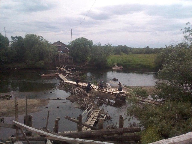 Местные жители своими силами строят мост через реку (6 фото)